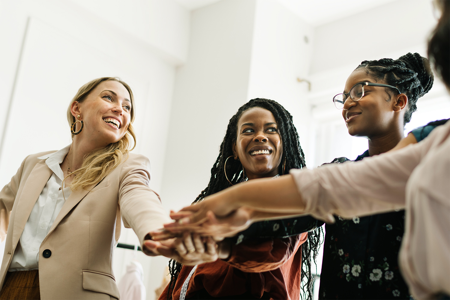 Empowering businesswomen stacking their hands